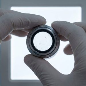 Take off the eyepiece, objective or adapter, put against a white paper or bright background, and find the dirt.